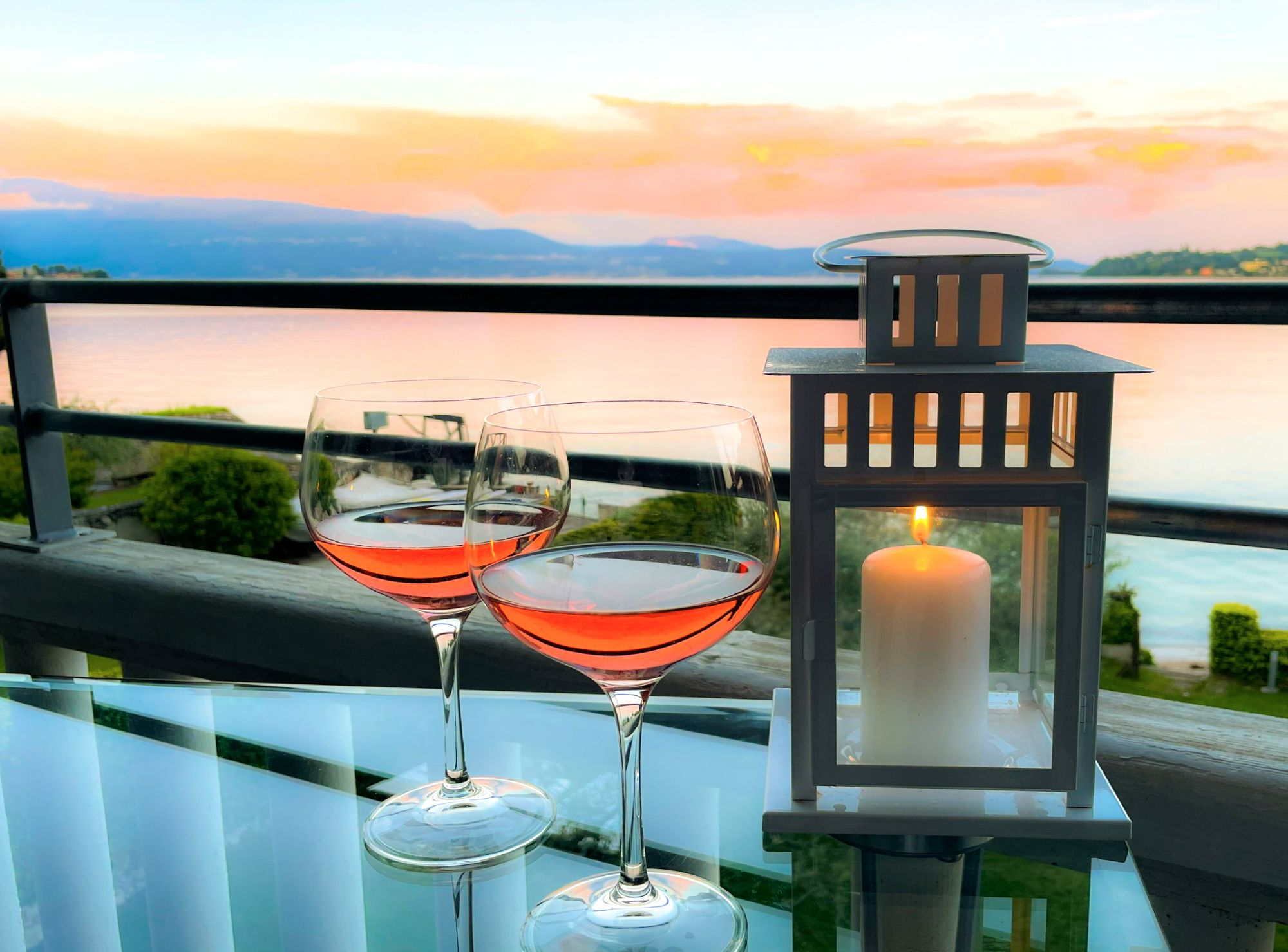 small table with glass of wine during sunset